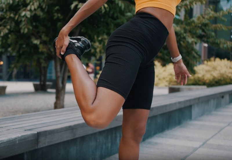 Woman performing thigh-strengthening exercises outdoors