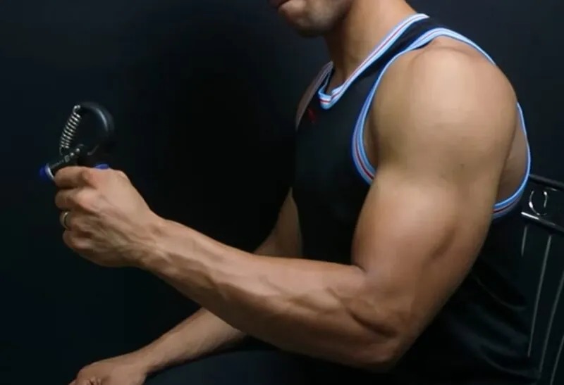 Close up of a Man holding Grip Trainer