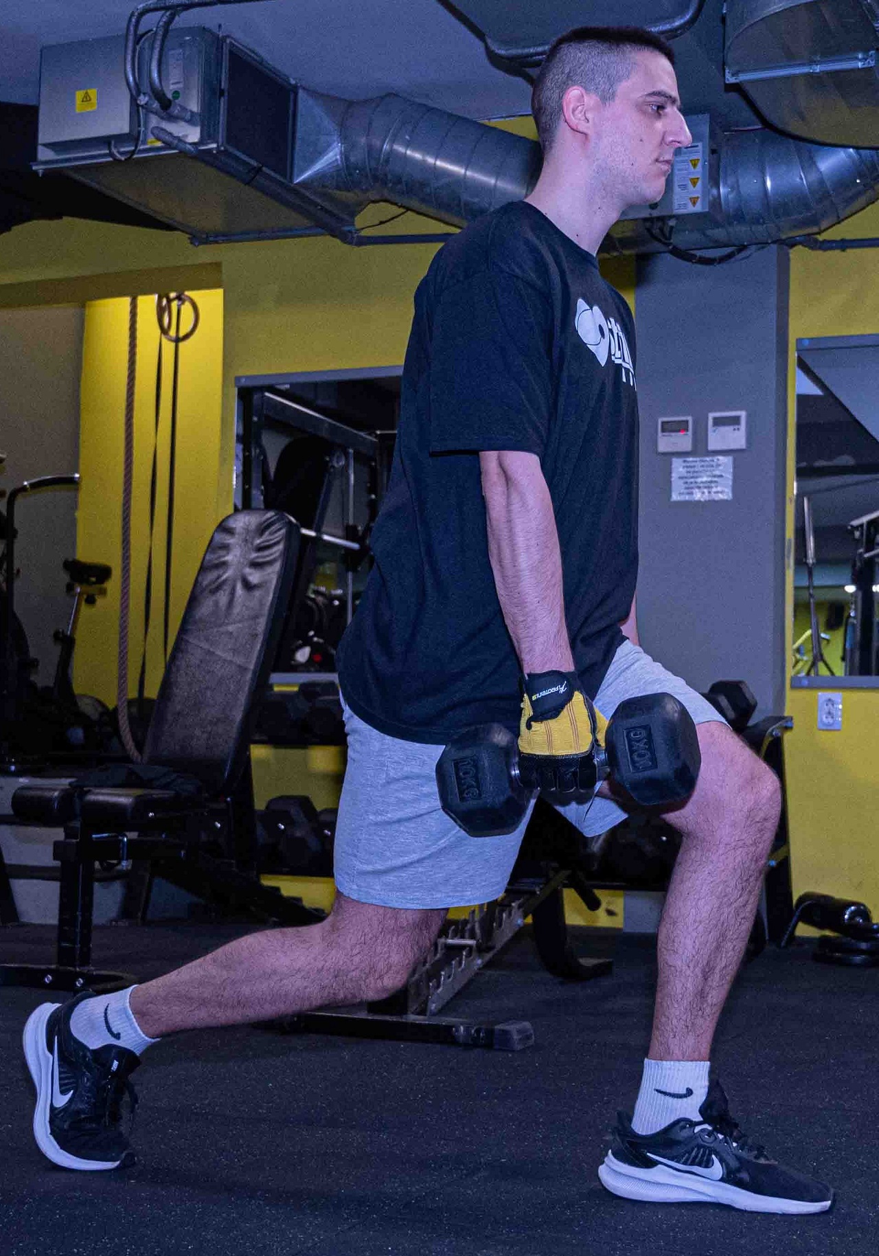 A guy performs Lunges with Dumbbells