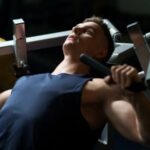Guy working out and doing his exercises on chest-press-machine